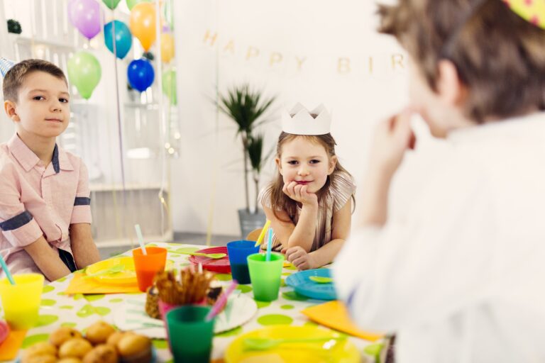 kids-colored-caps-sitting-table-min